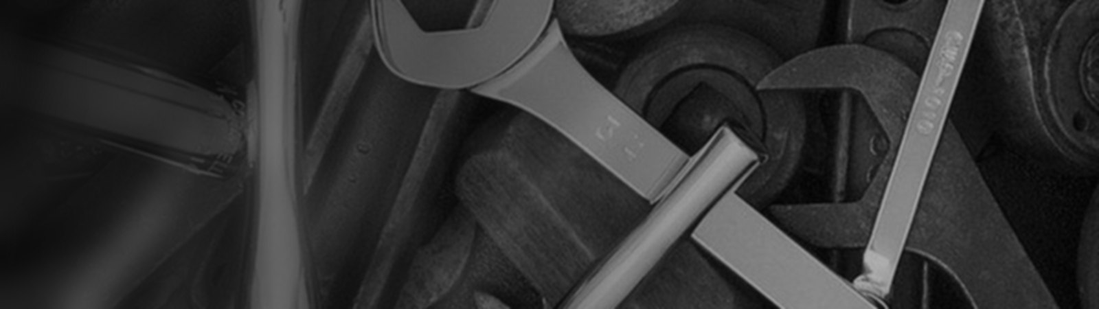 Assorted chrome hand tools — wrenches, ratchets and sockets